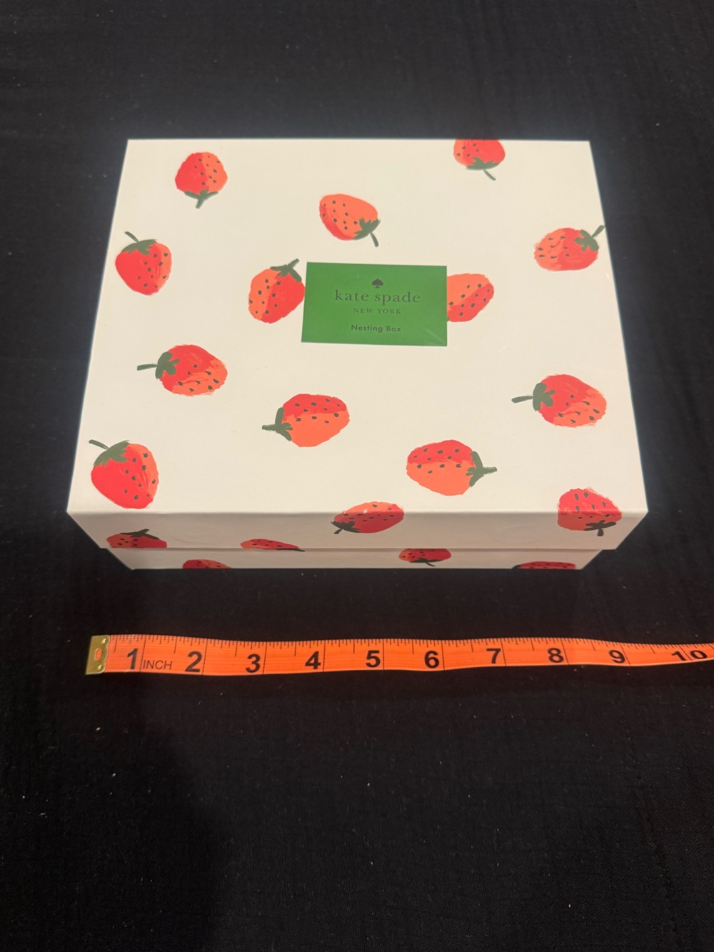 kate spade white box with red strawberries and green label